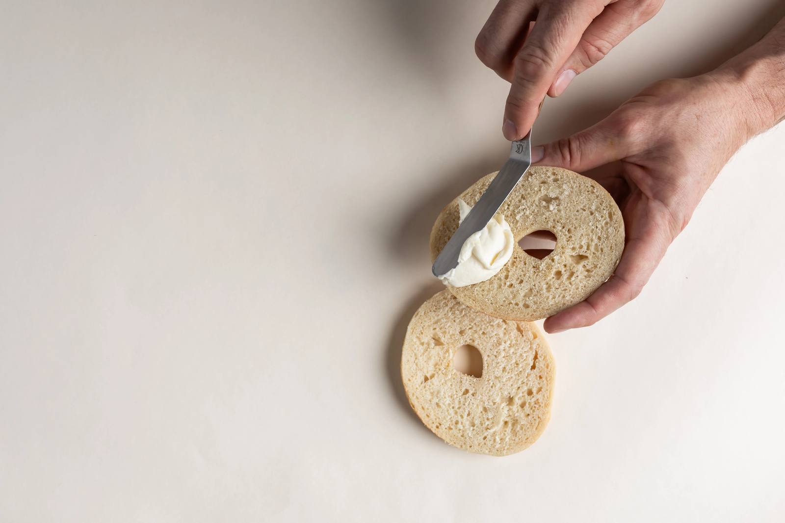 Cream cheese spread on a fresh Ugly Bagel