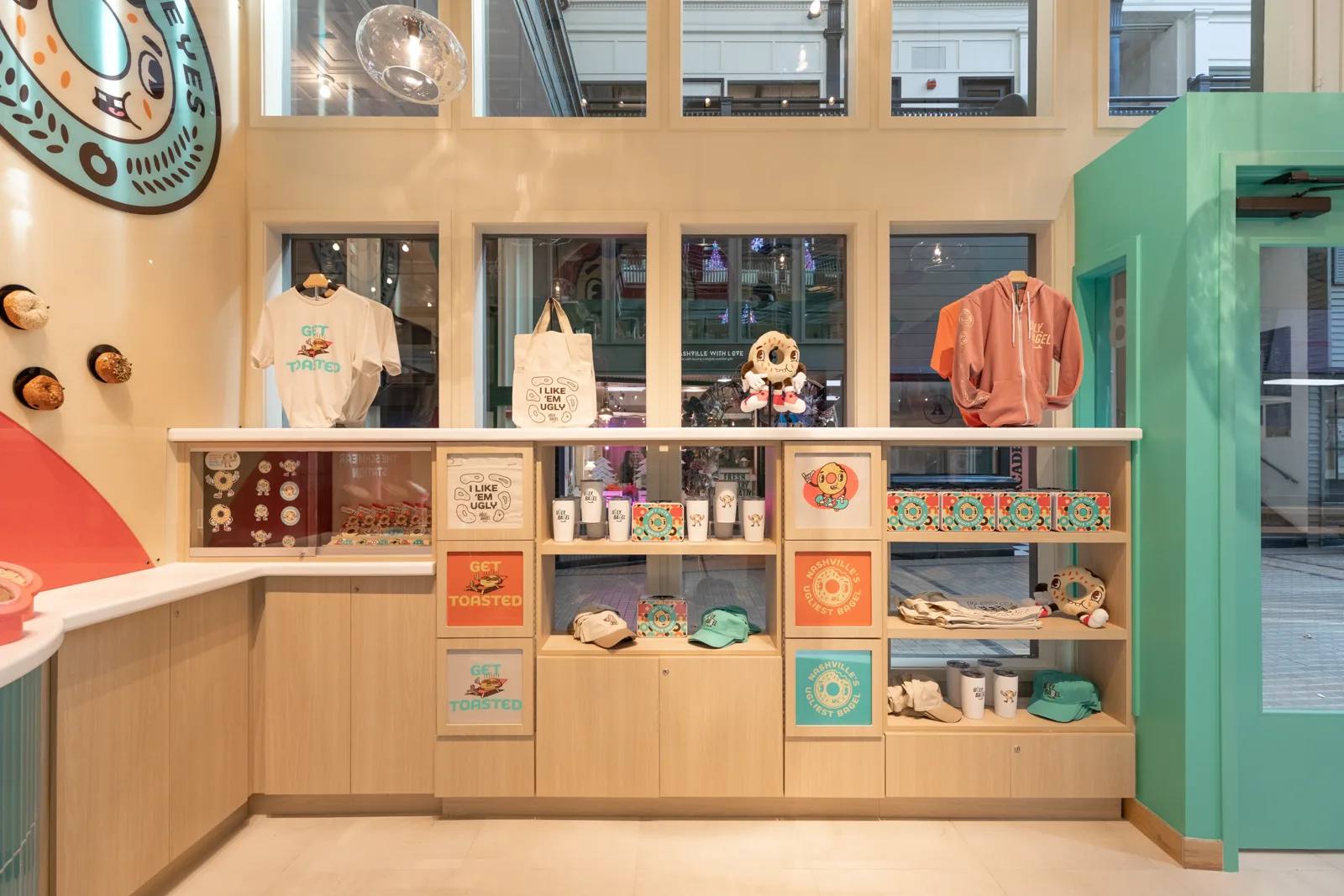Merchandise shelving beside the Ugly Bagel retail counter