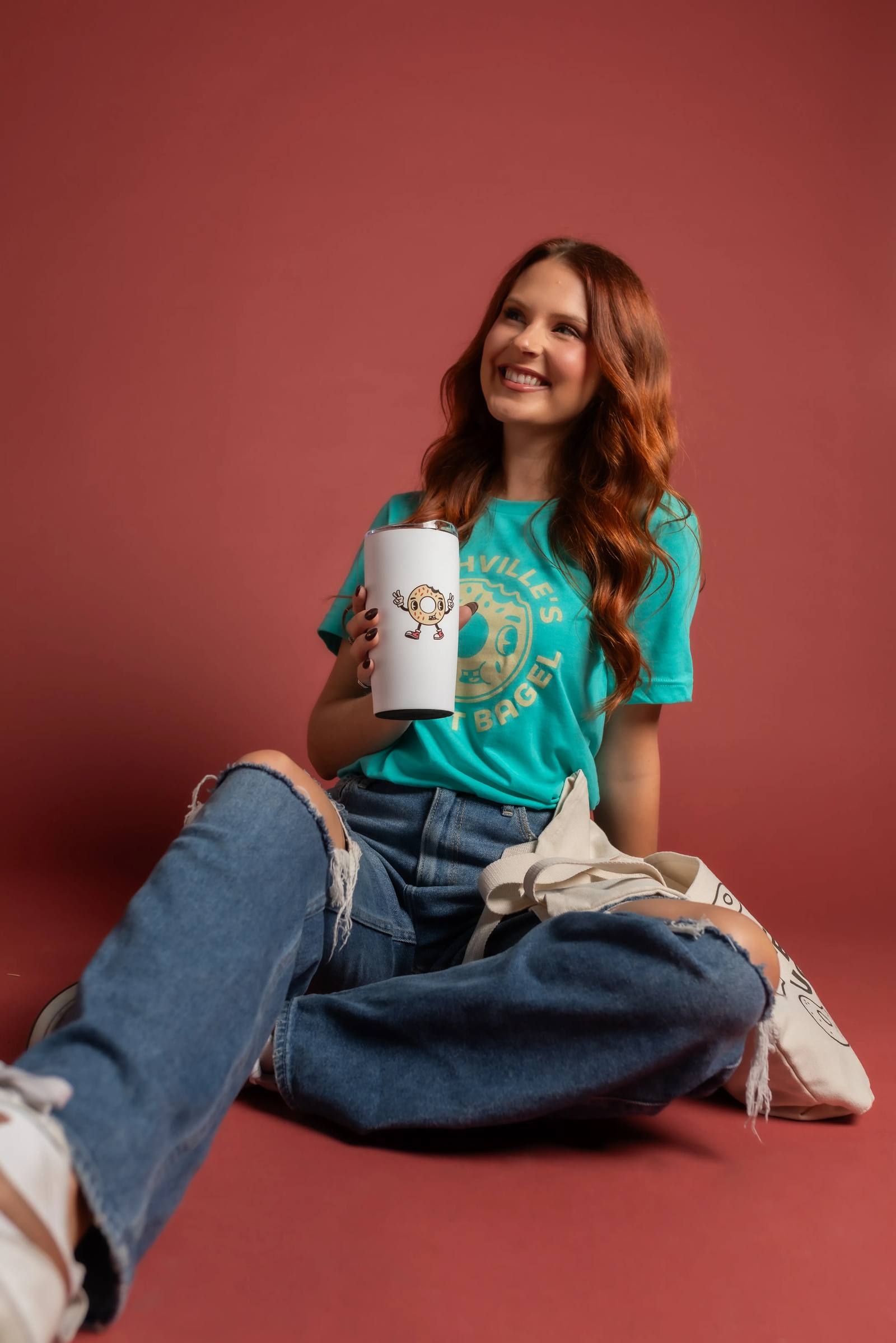 Ugly Bagel guest enjoying coffee with a branded tote