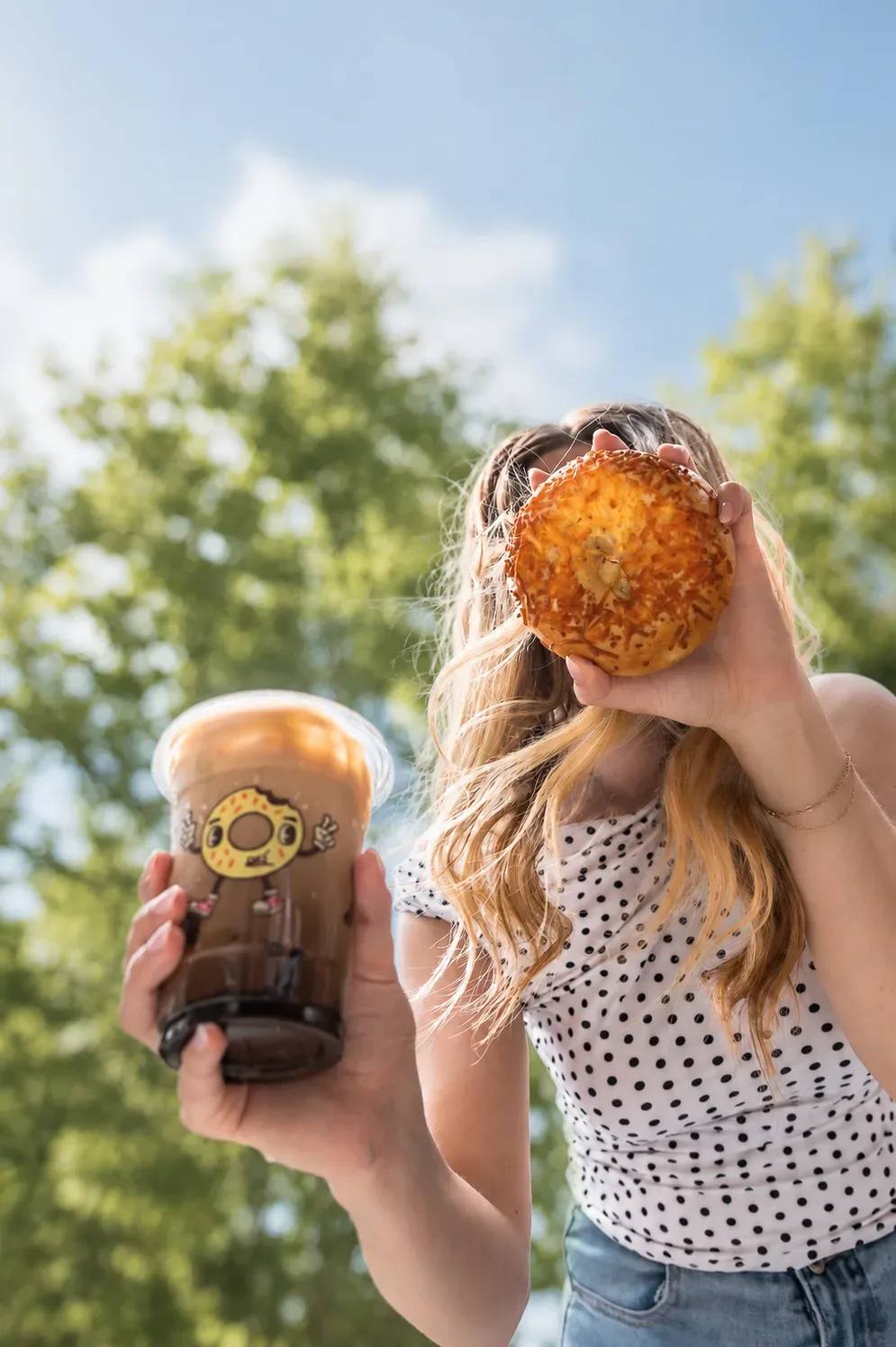 Ugly Bagel coffee and bagel enjoyed outdoors